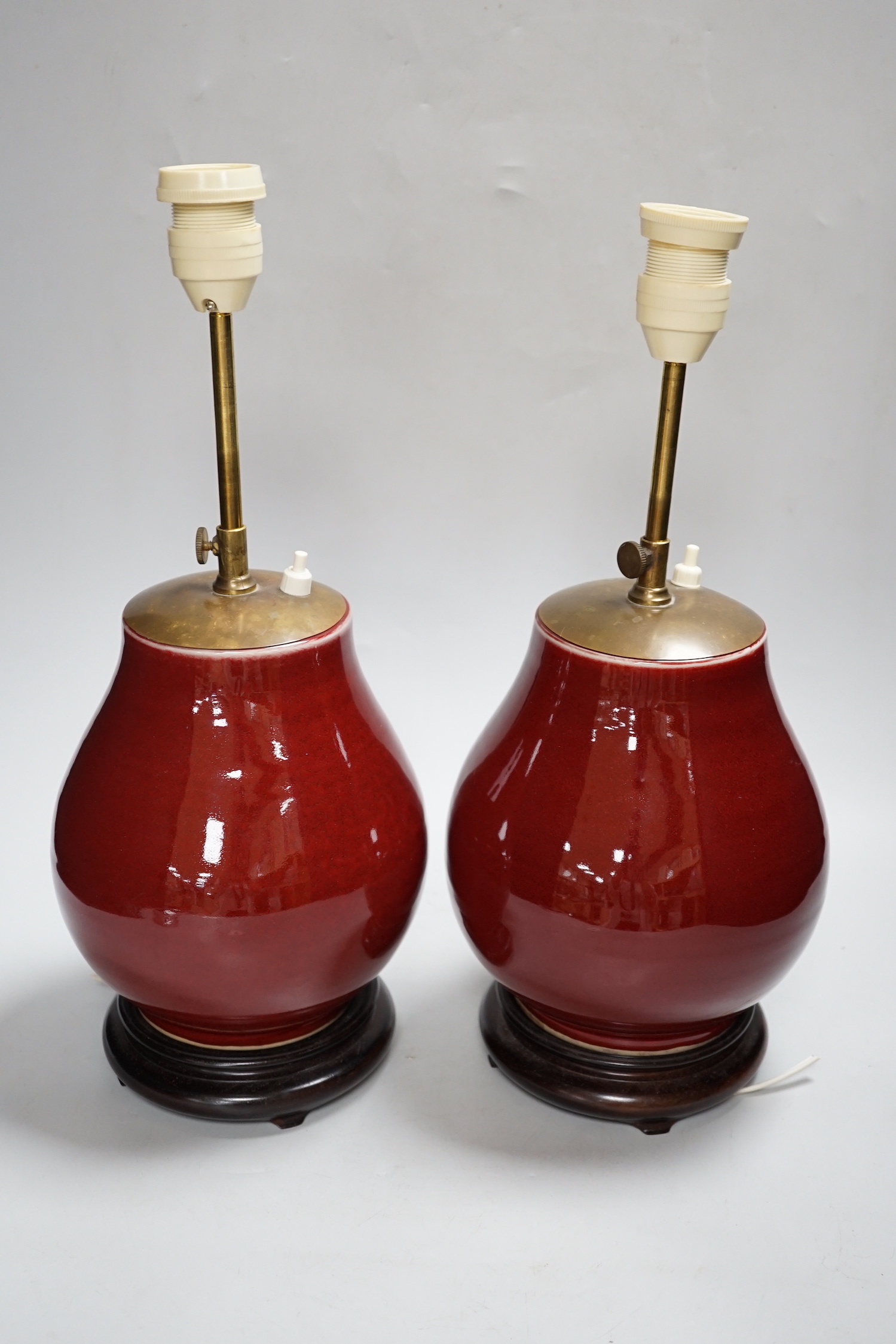 A pair of Chinese sang de boeuf glazed vases, mounted as lamps 23cm high excluding light fitting